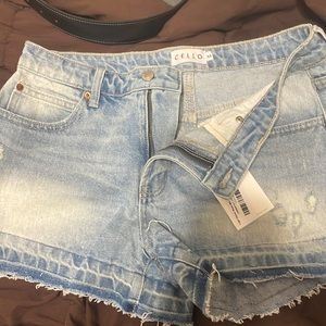 Light colored jean shorts, slightly frayed bottoms, size medium